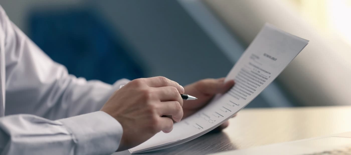 Man in white shirt reviewing CV