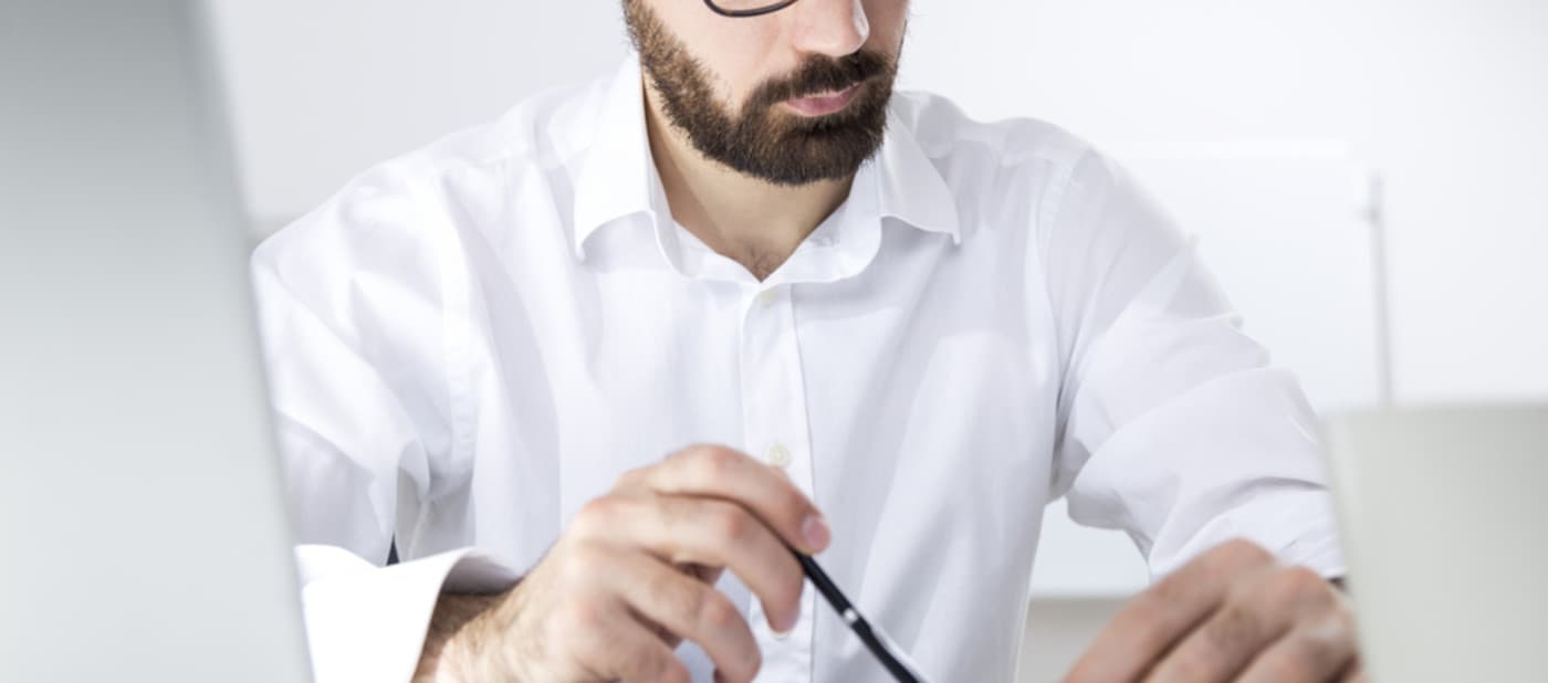 Man working at desk in white shirt