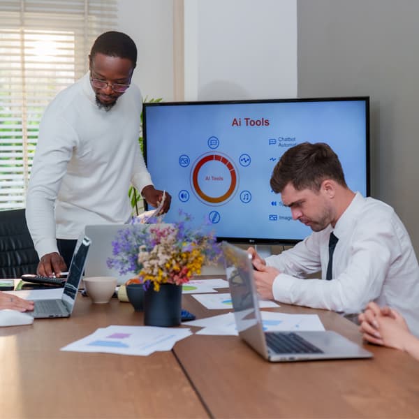 An in modern business setting, team collaborates on technology and marketing strategies, utilising ai tools for analysis and innovation. Atmosphere is focused and productive.