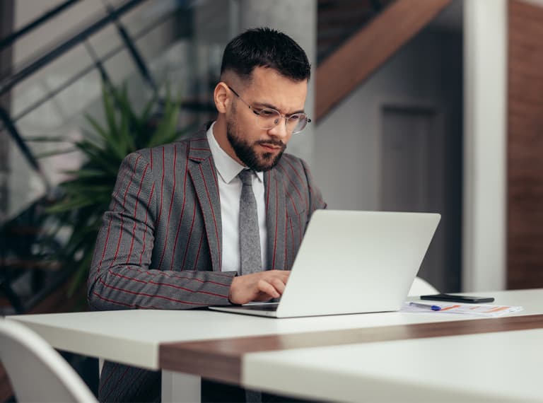 Businessman working on laptop in the office.