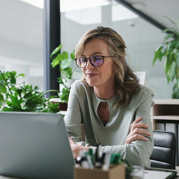 Woman at desk using AI at work