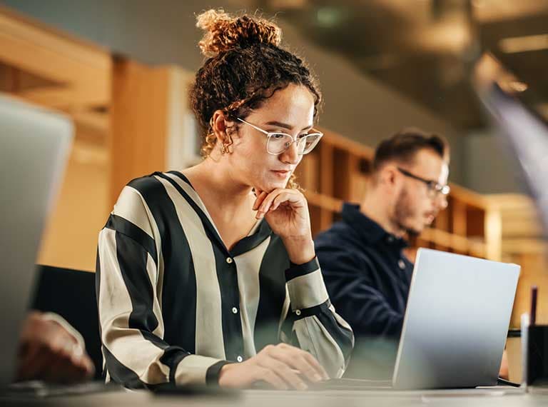 Woman returned from maternity leave and concentrating at computer