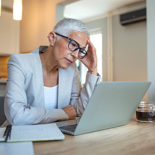 Mature woman in the office looking stresses