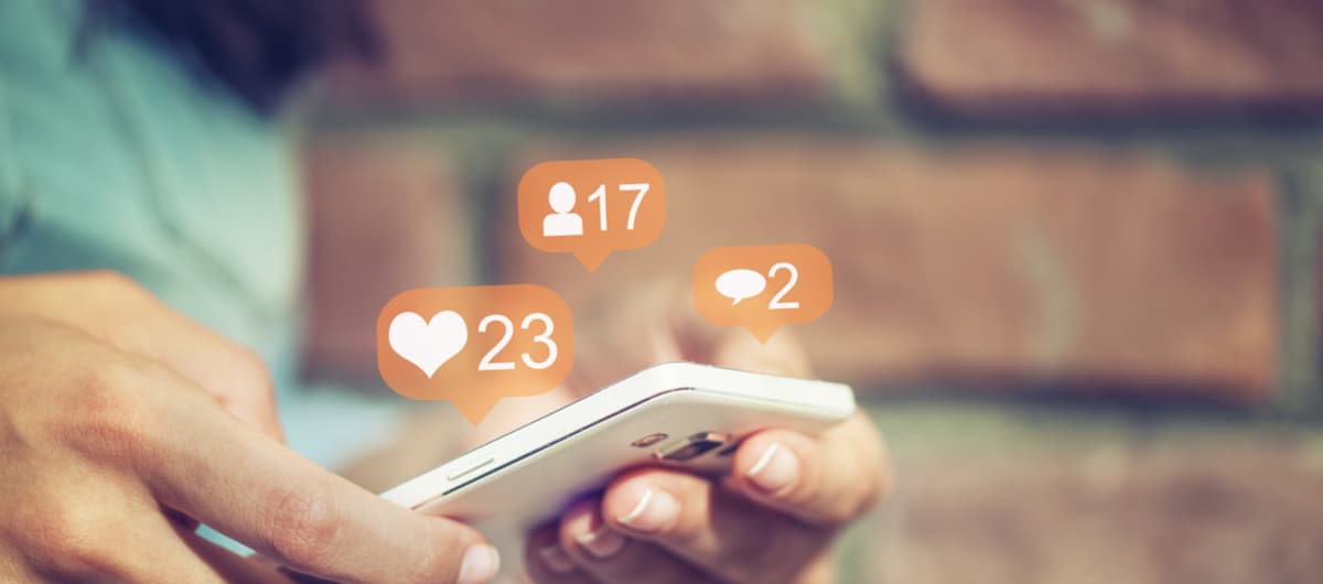 Phone surrounded by social media icons