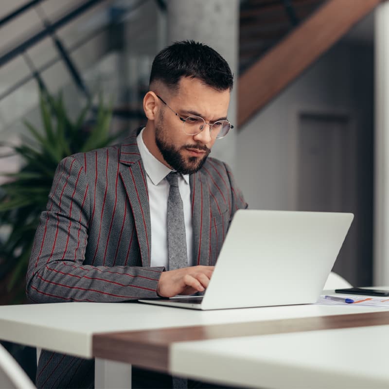 Businessman working on laptop in the office.