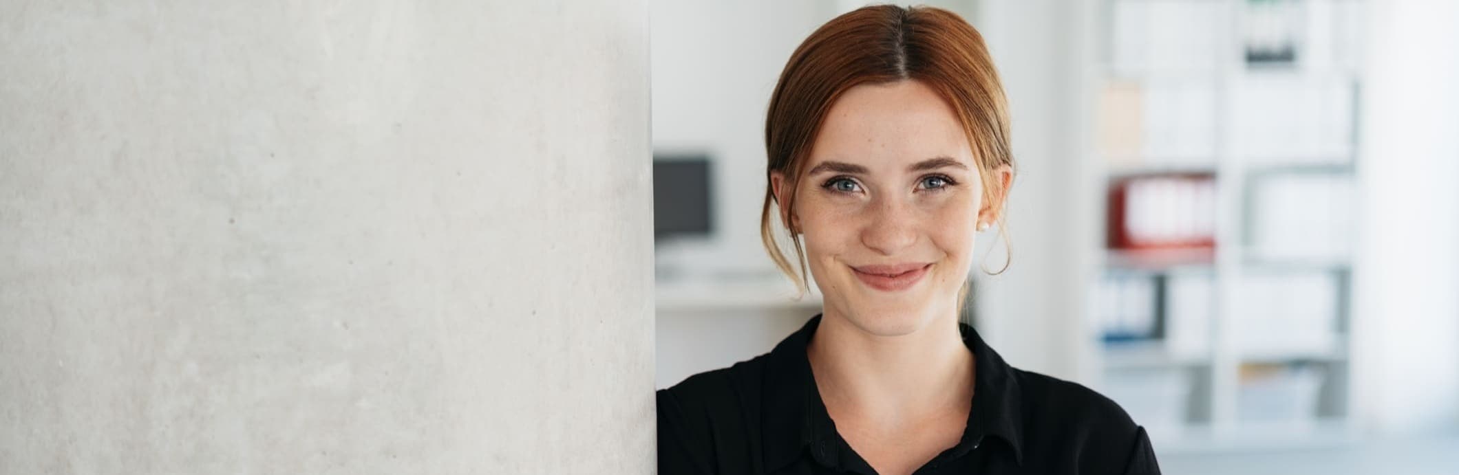 Friendly young businesswoman smiling at camera